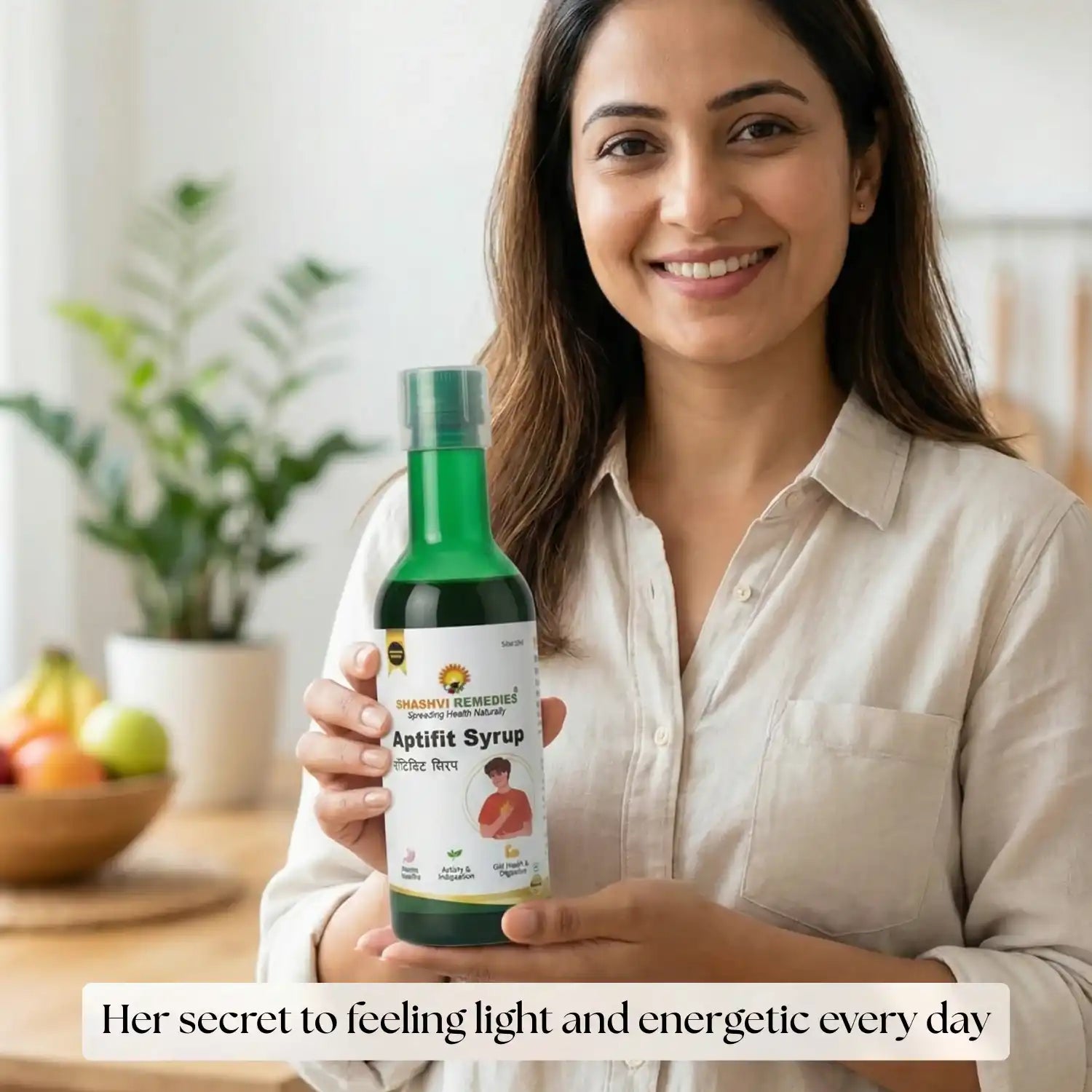 Woman holding a bottle of Aptift Syrup with a blurred indoor background